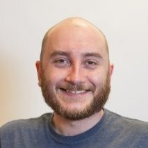 Person smiling at the camera with a beard and short hair.