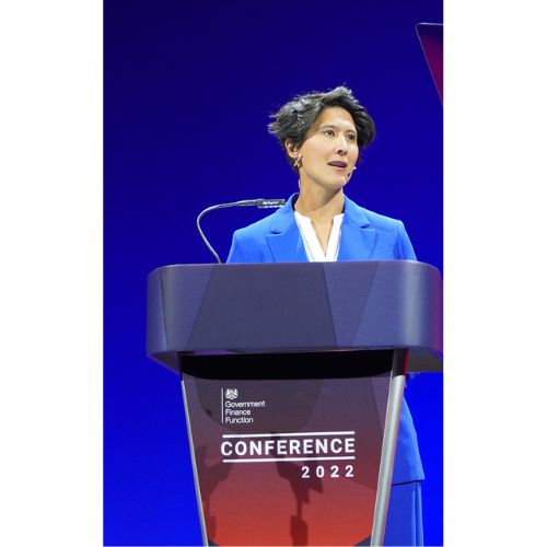 Person speaking at a podium during a 2022 conference.