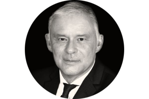 Black and white portrait of a person wearing a suit and tie.