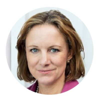 Person with short hair and a pink blazer.