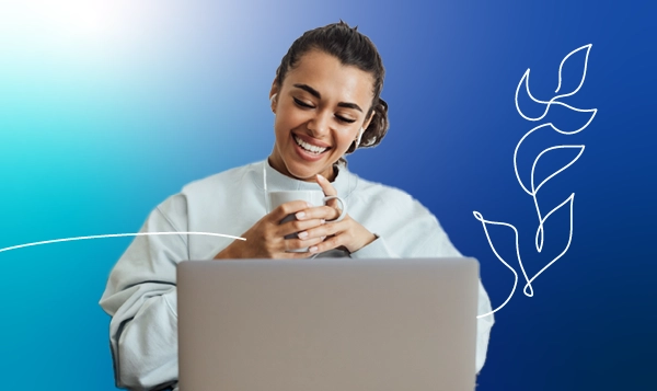 A lady with a laptop sitting in an office building.