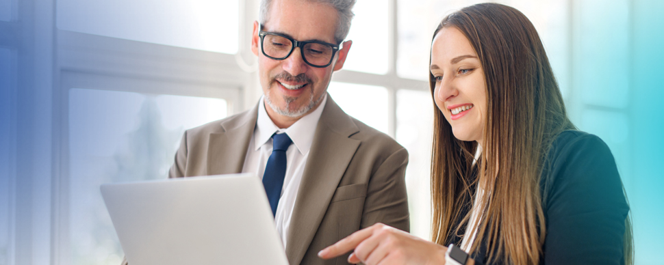A man and a woman looking at a laptop