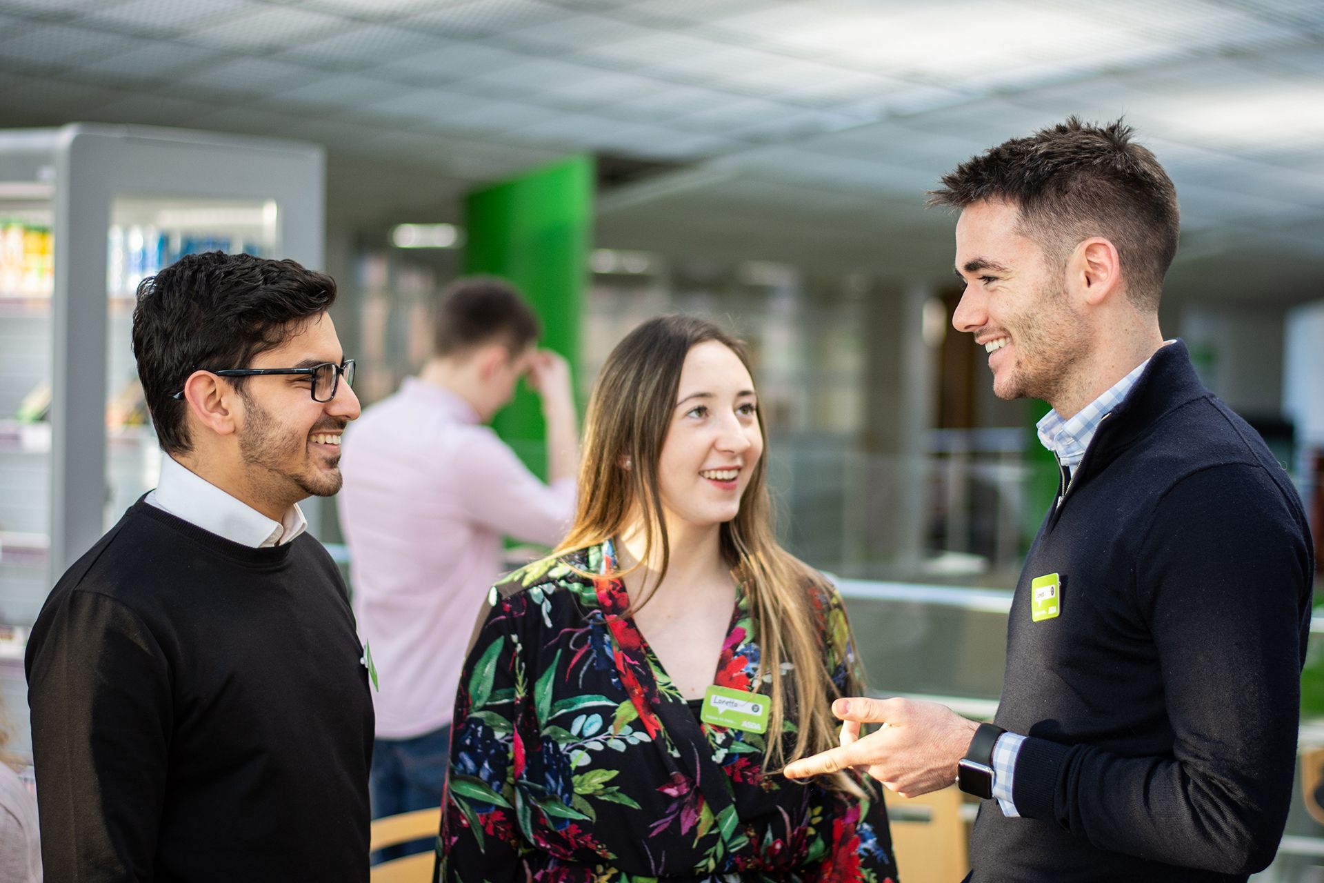Three Asda employees in a converswation