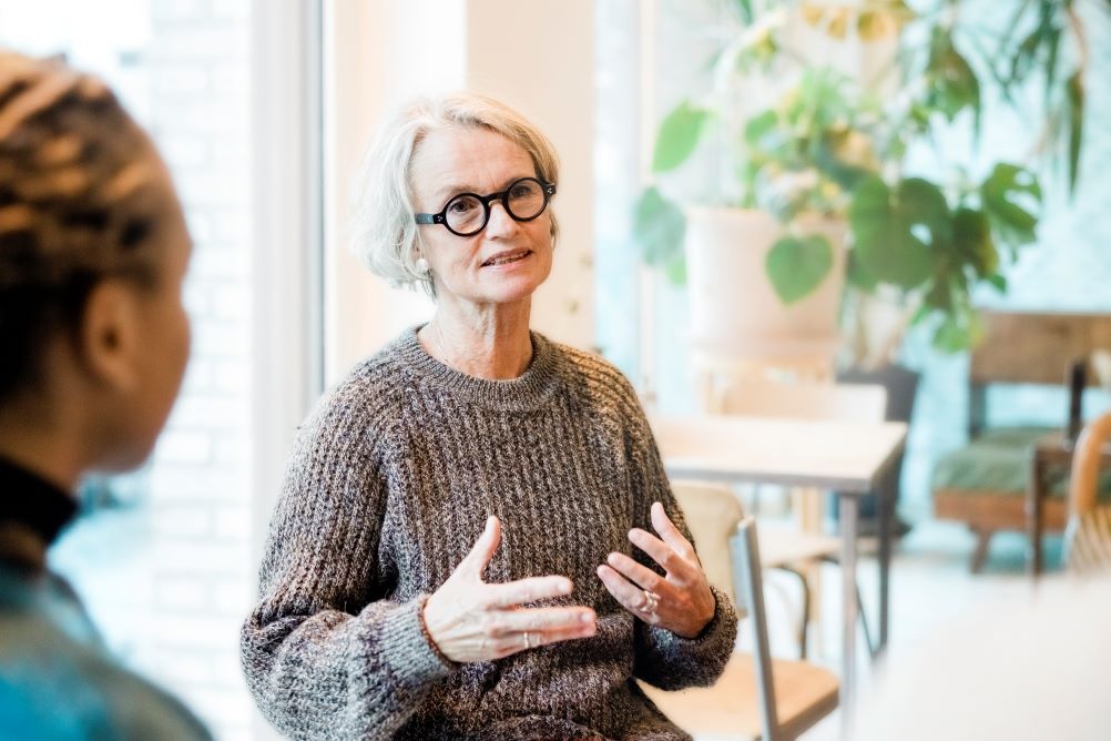middle-aged woman in a group conversation