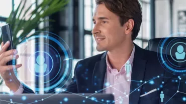 Person using smartphone with digital network graphics overlay.