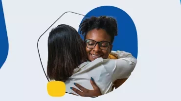 Two people hugging with smiles