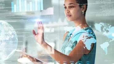 Person interacting with digital display showing global maps and data.