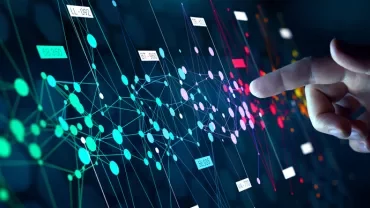 Hand interacting with a colorful digital data network on a virtual screen.