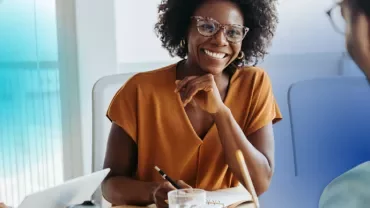 smiling woman who is hiring an interim manager