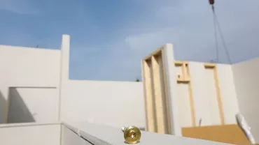 Unfinished building with visible wall structures and a golden object on the ledge.