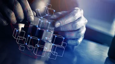 Hands assembling a wooden puzzle with digital cubes overlay.