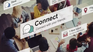 A group of people sitting at a table with digital notifications popping up.