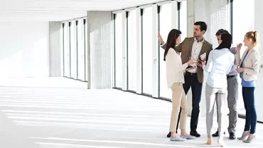 Group of people discussing in a bright office space.