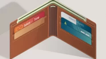 Open brown wallet with credit cards inside.