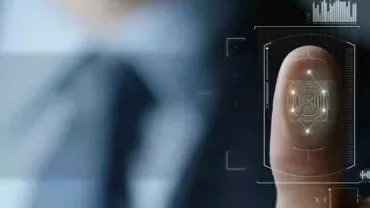 Close-up of a finger on a digital screen with holographic interface.