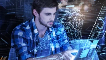 Person working on a digital interface with holographic data projections.
