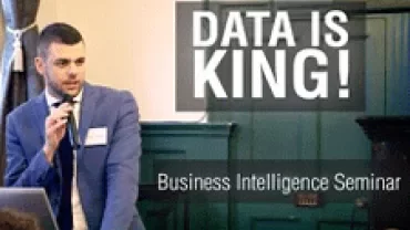 Speaker at Business Intelligence Seminar with 'Data is King' on screen