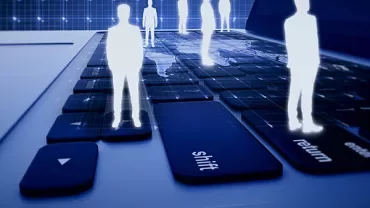 Digital figures standing on a keyboard in a blue-hued virtual environment.