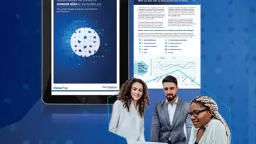 Team discussing gender bias report on laptops.