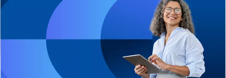 Older lady holding ipad in front of blue background