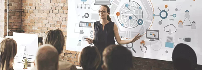 Person giving a presentation on digital network concepts to a group.