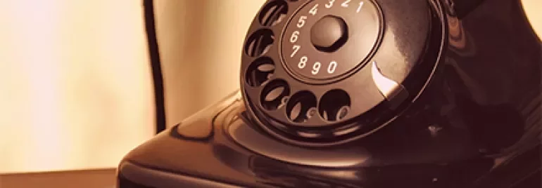 Vintage rotary dial telephone on a table