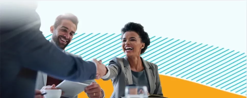 3 people smiling and shaking hands