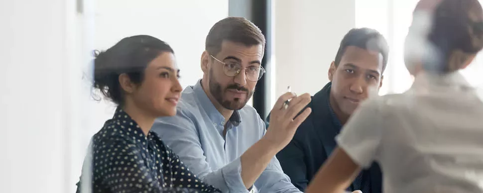 A group of people having a discussion at a meeting.