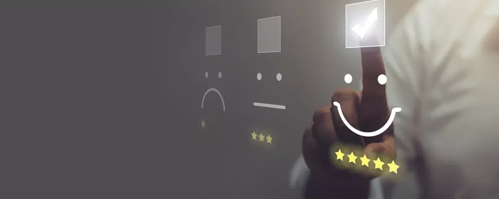 Person selecting a happy face with five stars on a virtual screen.