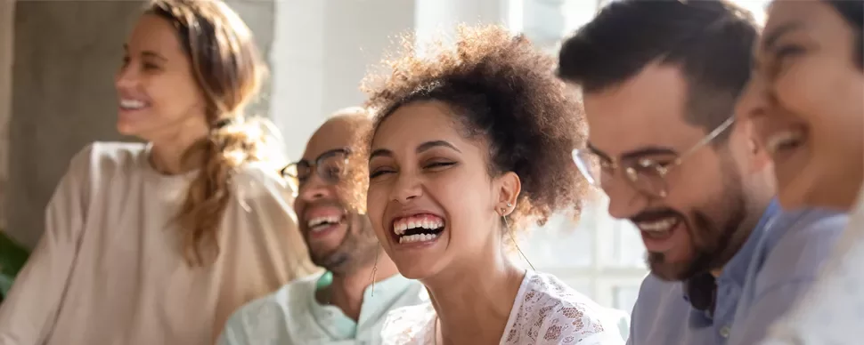 Group of people laughing together indoors.