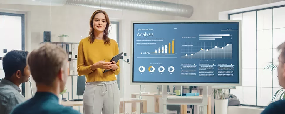 Person presenting a data analysis chart in a meeting room.