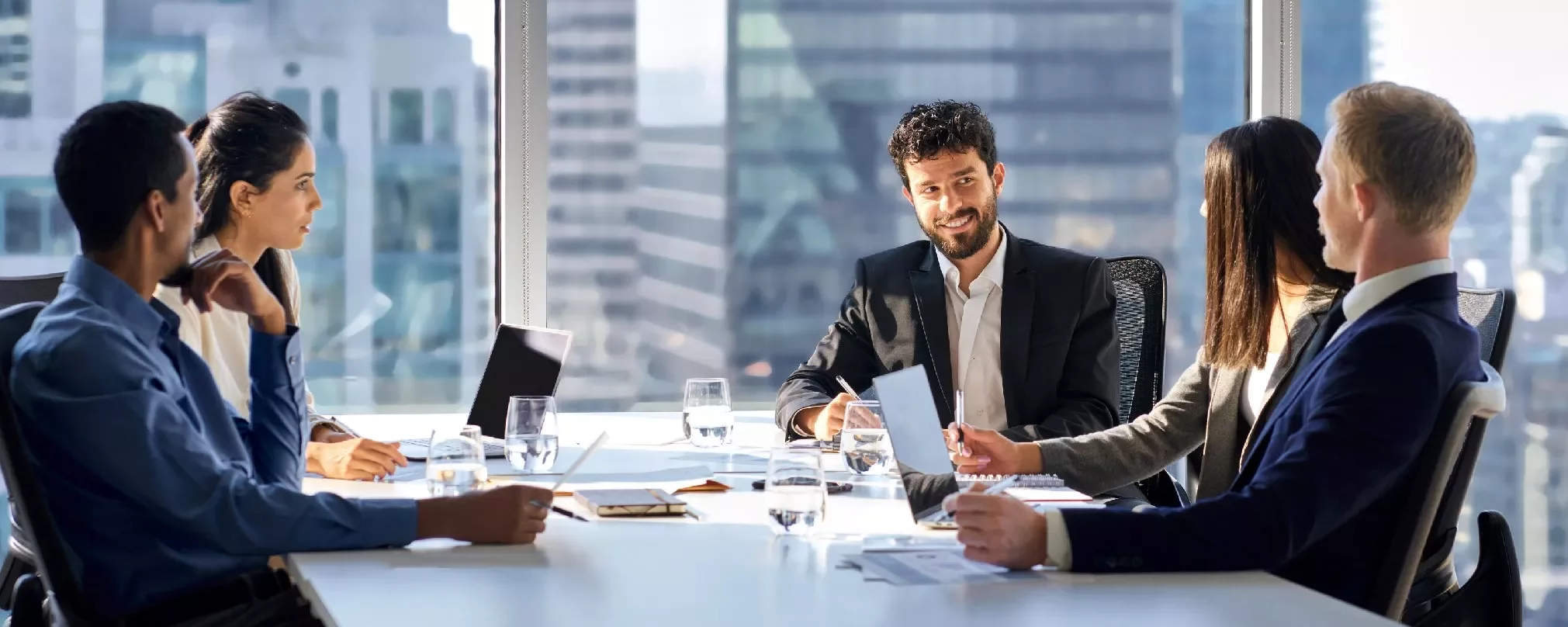 Group of people in a modern office meeting.