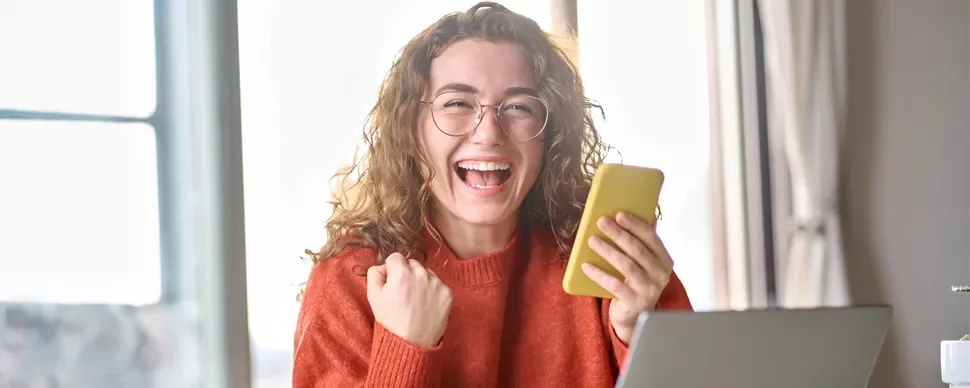 happy woman holding yellow phone