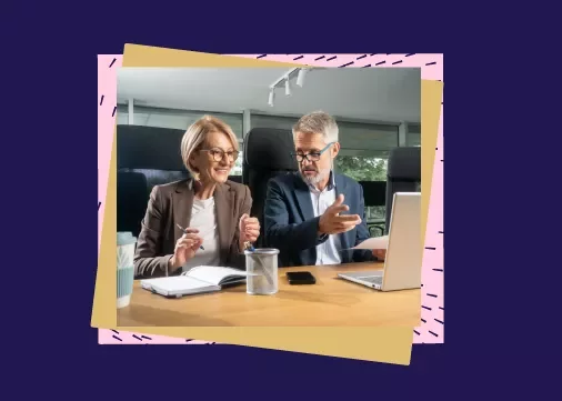 2 people in business attire talking in an office setting