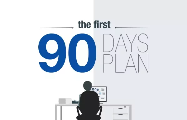 Person at desk with computer under 'The First 90 Days Plan' text.