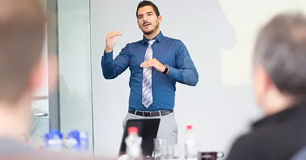 Person giving a presentation in a conference room.