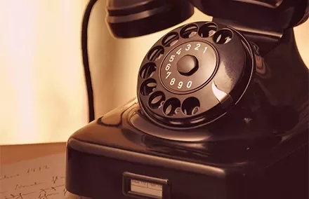 Vintage rotary dial telephone on a table