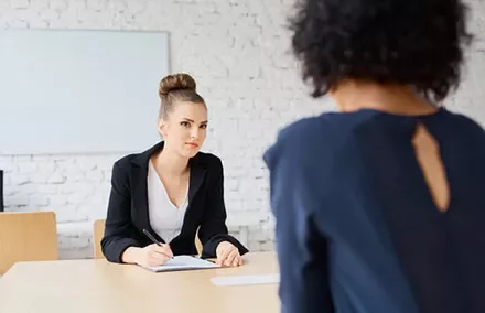 Two people during a meeting in a bright office setting.
